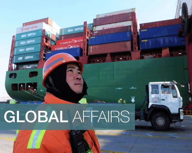  A worker watches cranes at the port in Qingdao, China, on Feb. 15. (STR/AFP/Getty Images) 